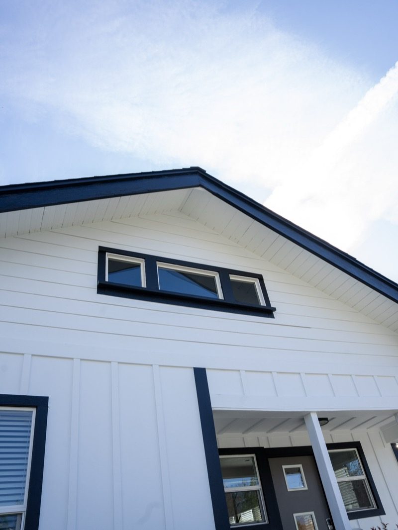 Finished modern craftsman home with white siding and black trim — full residential remodel by Renovations INC